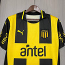 Camiseta hombre Peñarol temporada 2025 2026 primera equipación local listrada amarillo y negro escudo bordado calidad 1.1 oficial, Peñarol 2025, Camiseta Peñarol local, Peñarol 25/26, Camiseta Oro y Carbón, Camiseta barata Peñarol, Calidad 1.1 Uruguay, Fútbol Uruguayo 2026, Tienda Hincha Futbolero, Manya, Bloke Core Carbonero.